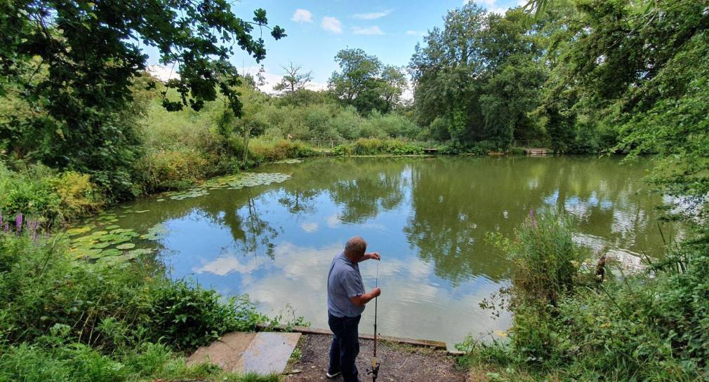 A lone angler at Perry Street Pond.