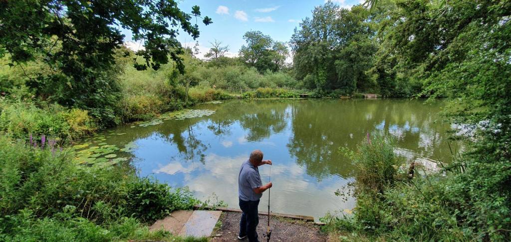 A lone angler at Perry Street Pond.